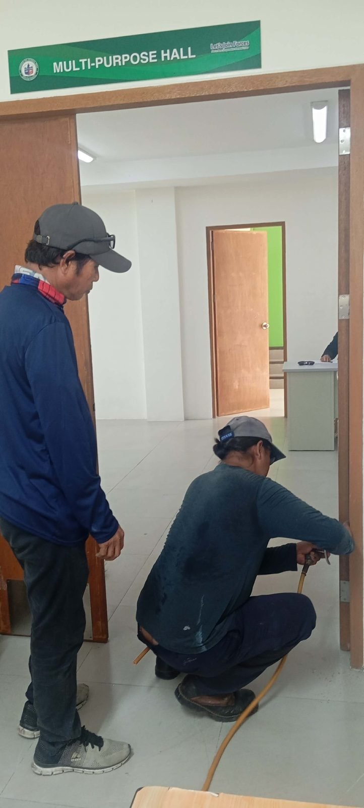 Novee technicians inspecting a door frame for termite activity